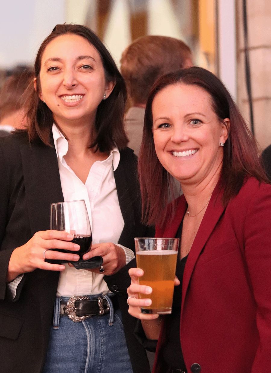 Two guests smiling with drinks
