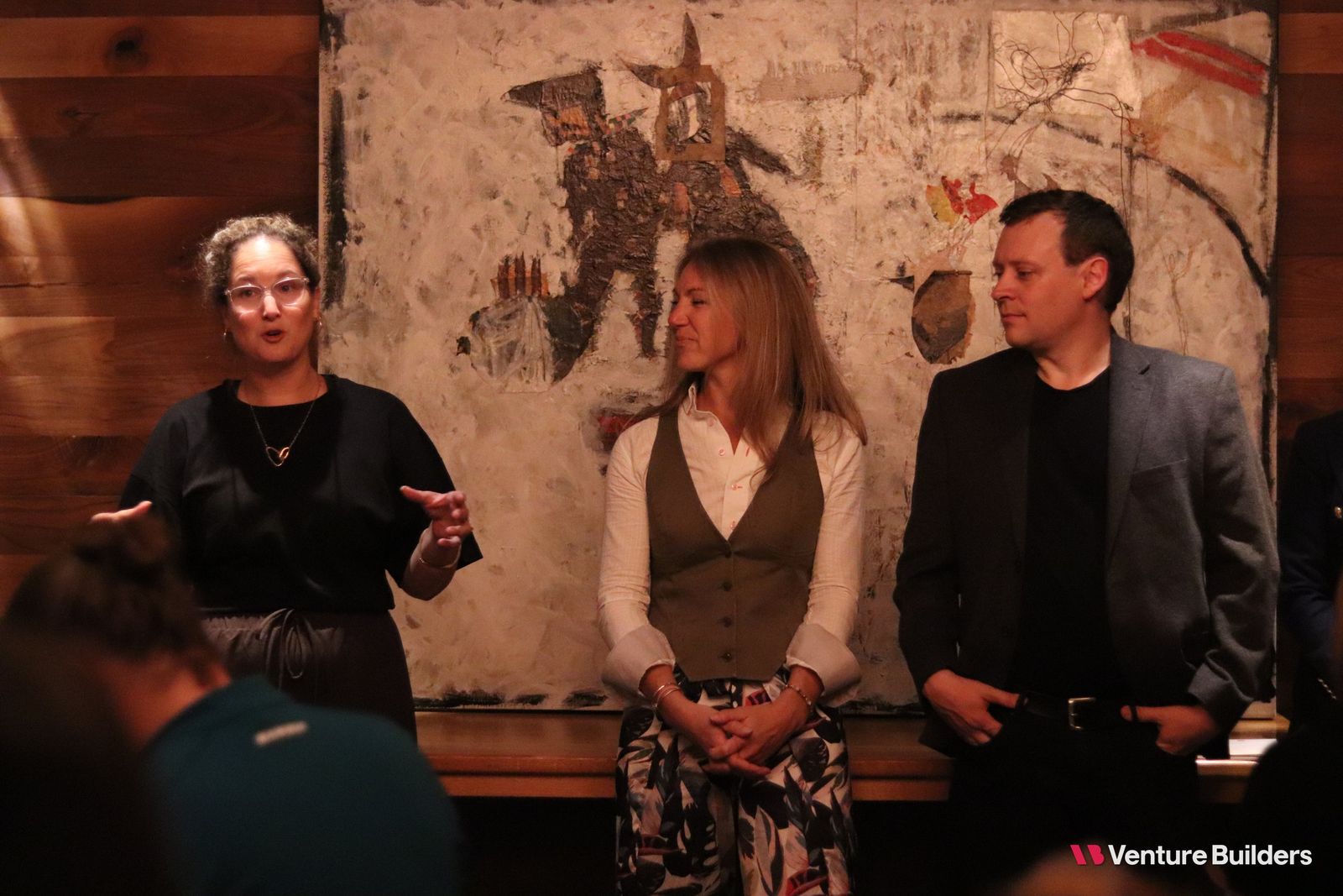 A sponsor speaking to the room during dinner