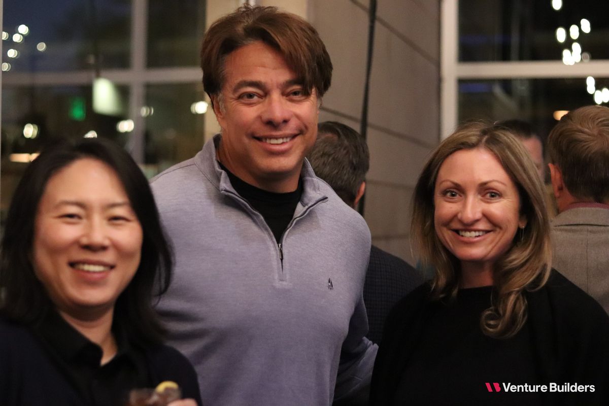 Three guests smiling at the Denver dinner